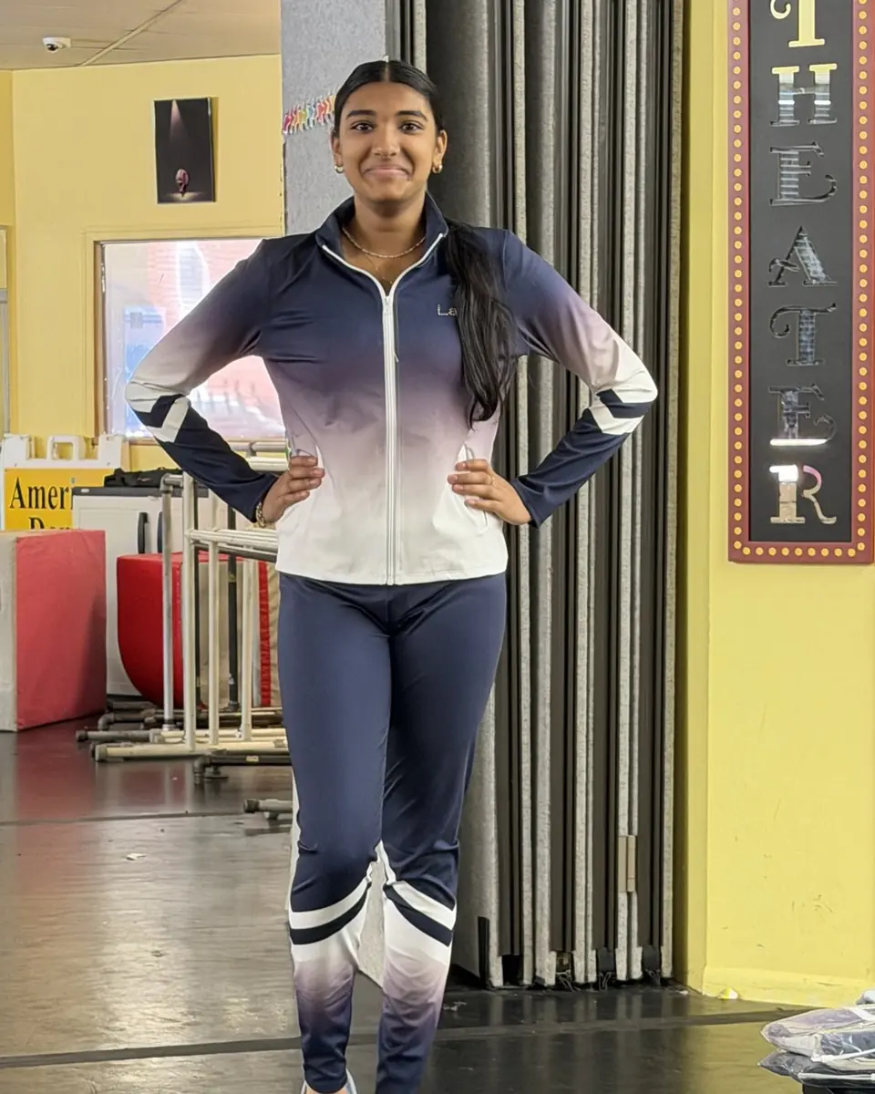 A teen dancer in the navy and white American Dance Studios team suit